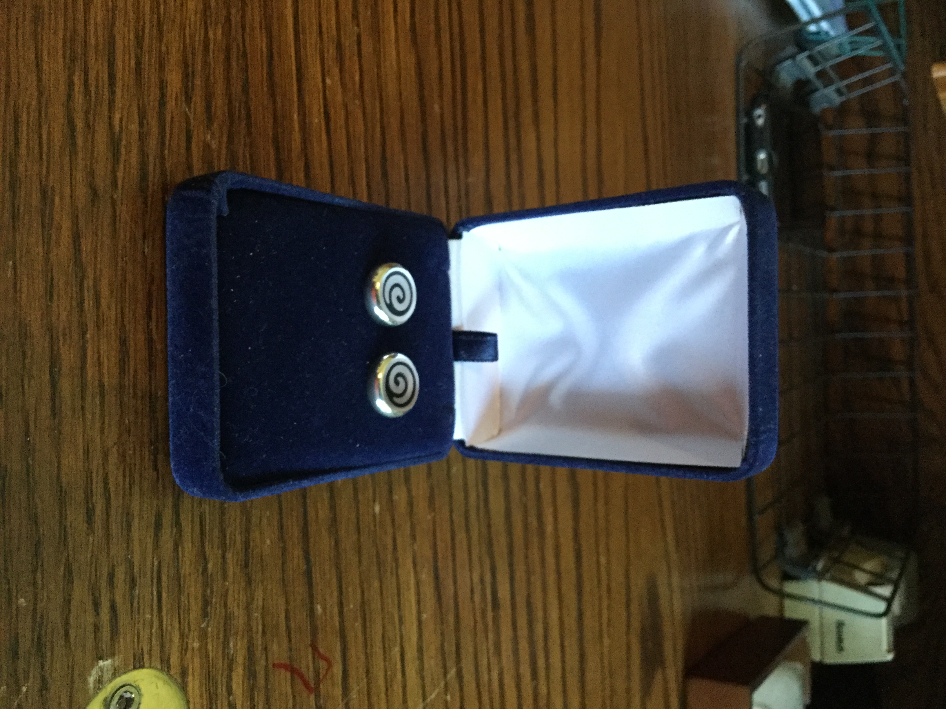Silver tone and black stud earrings.