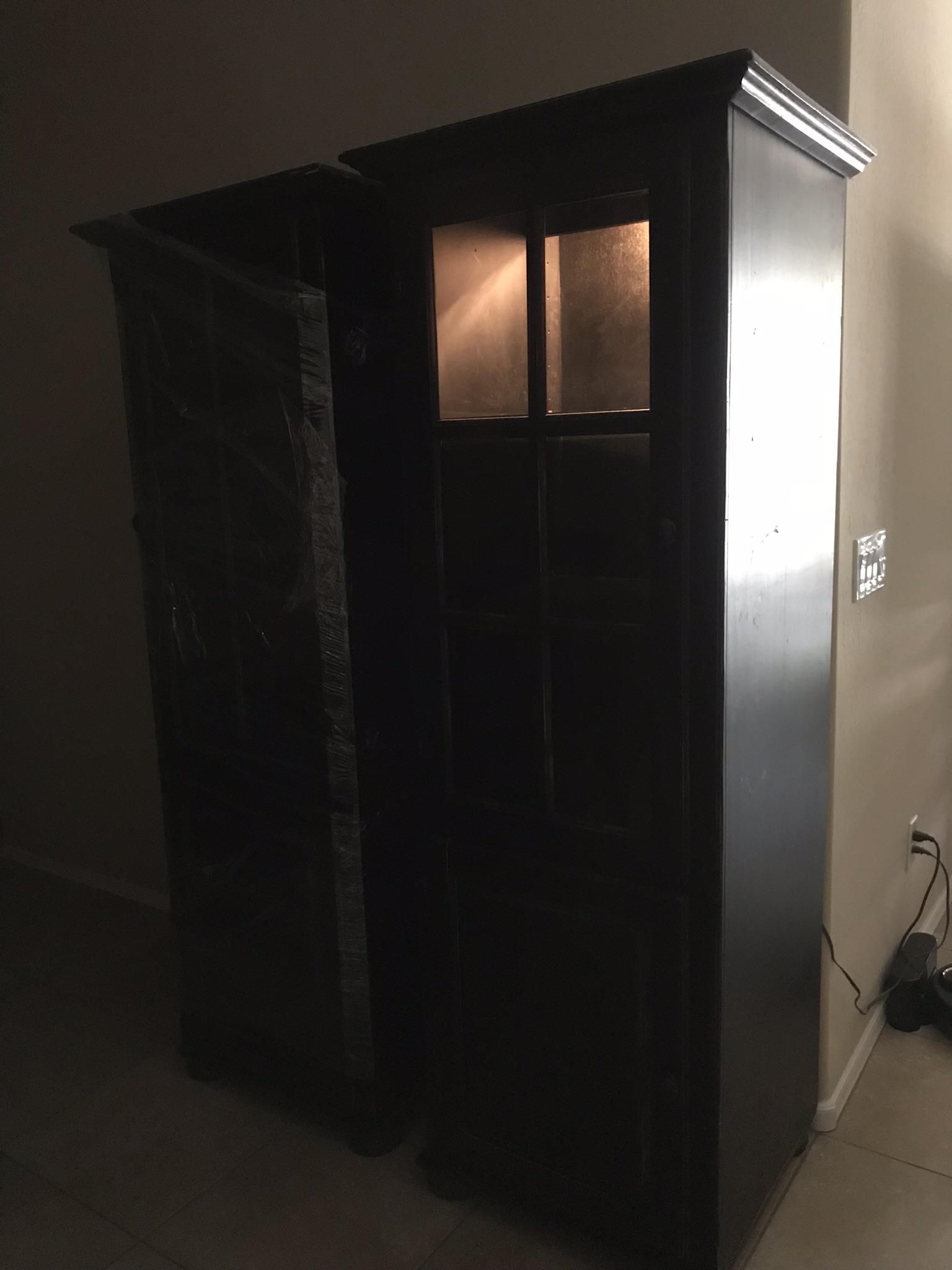Two large Black Distressed bookcases with lights and glass doors.