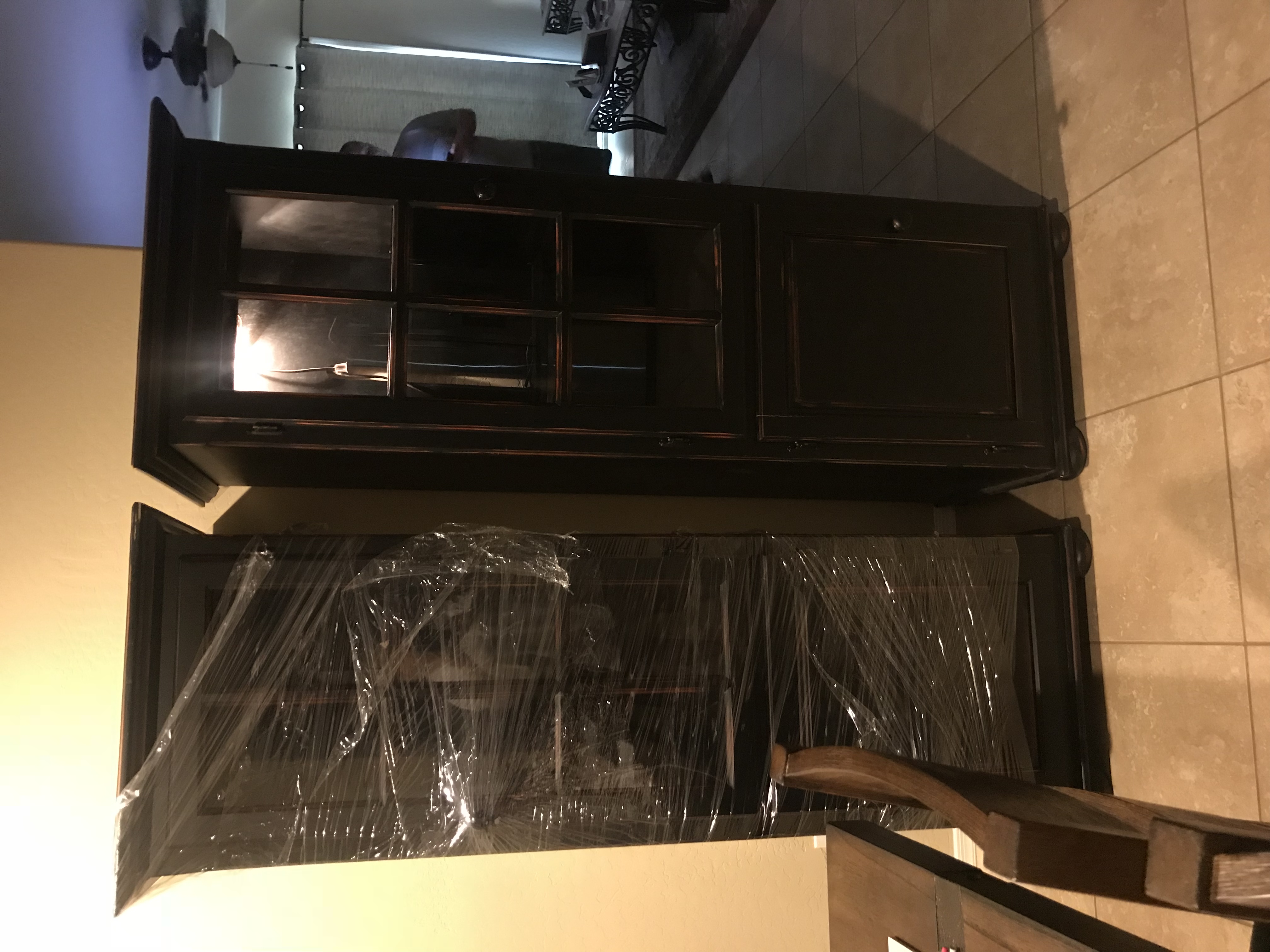 Two large Black Distressed bookcases with lights and glass doors.