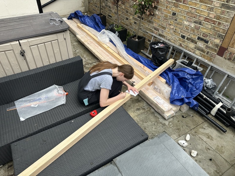 Katherine is doing some measurements on one of the beams