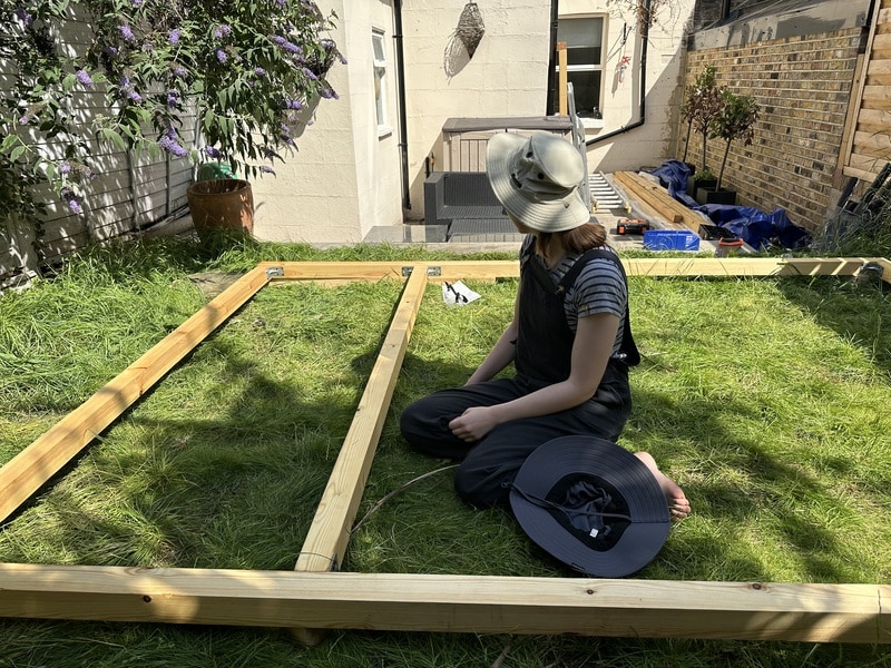 Katherine is sitting in the rectangle. Another vertical beam has been added to it.