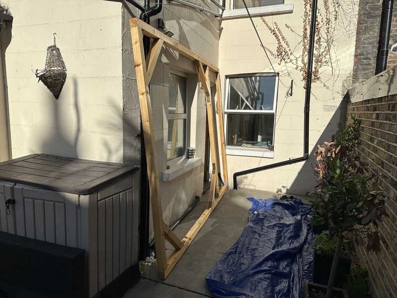 The first wall is finished. It leans against the house, in what will be its final position