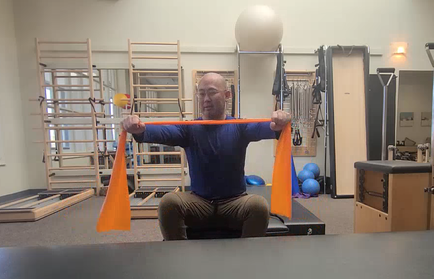 a man holding an orange band