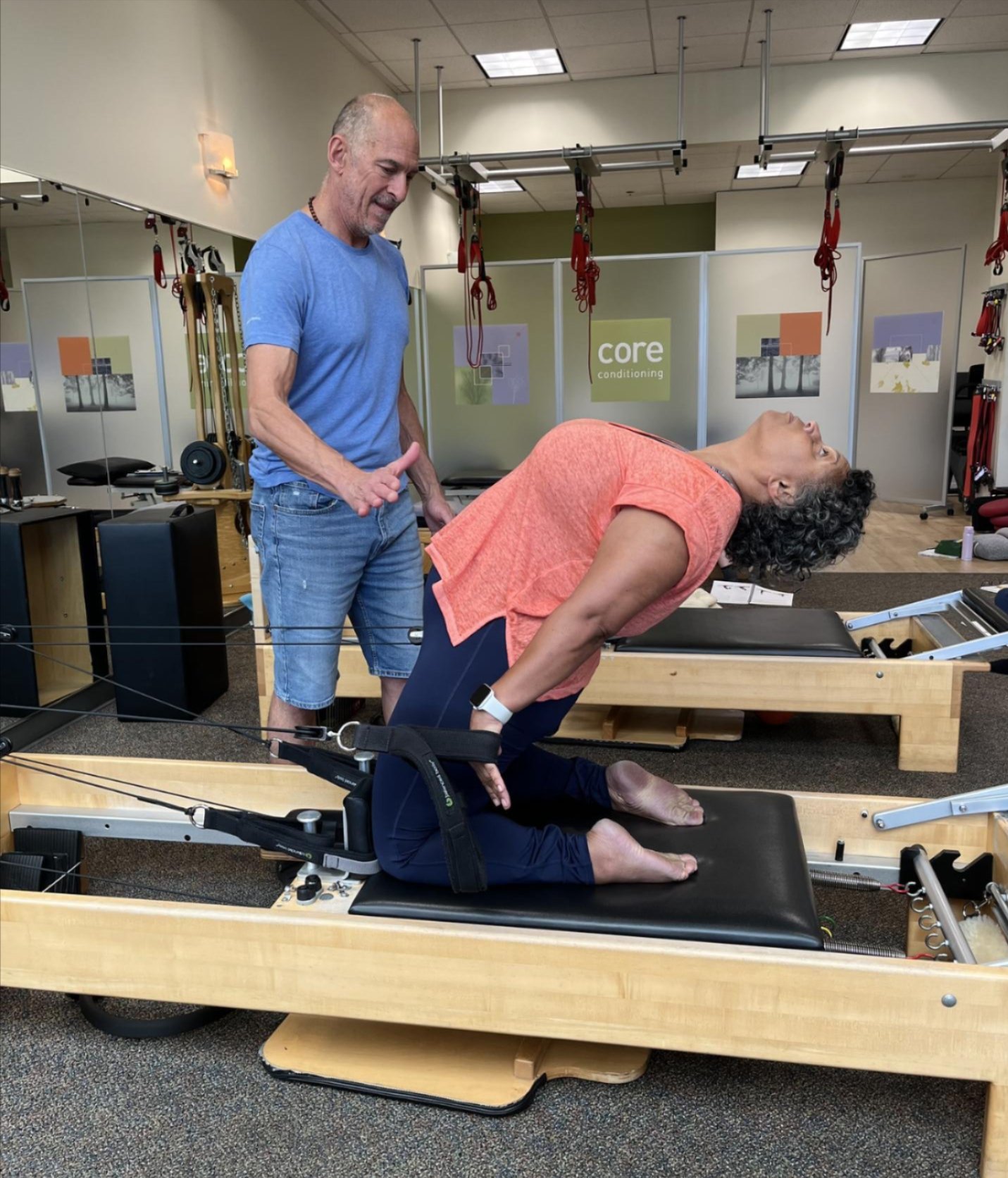 a man and woman on a reformer