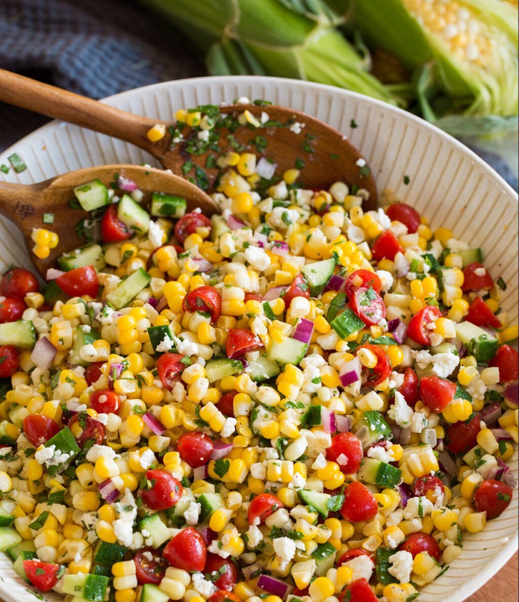 a bowl of salad with spoons