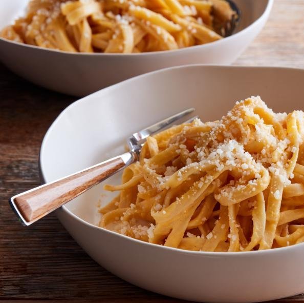 a bowl of pasta with a fork