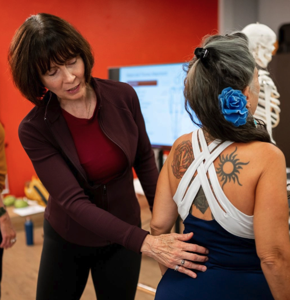 a woman touching a woman's back