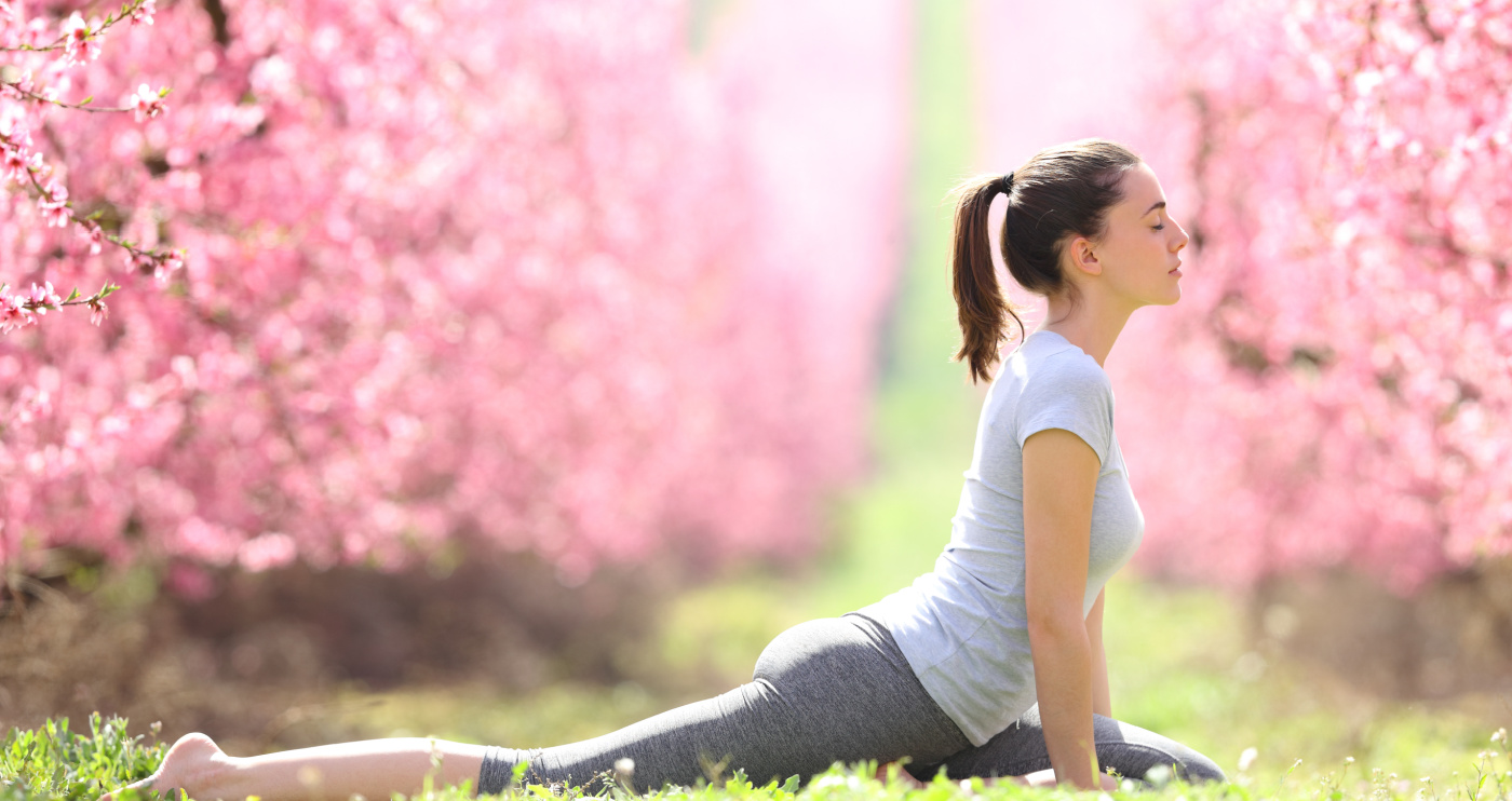 a woman doing yoga in the grass