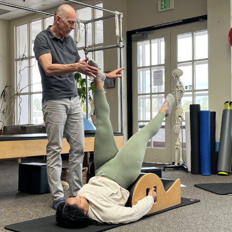 a man helping a woman do a exercise