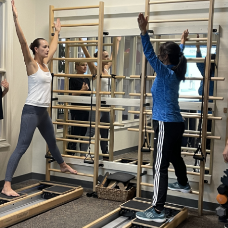 a group of people exercising in a gym