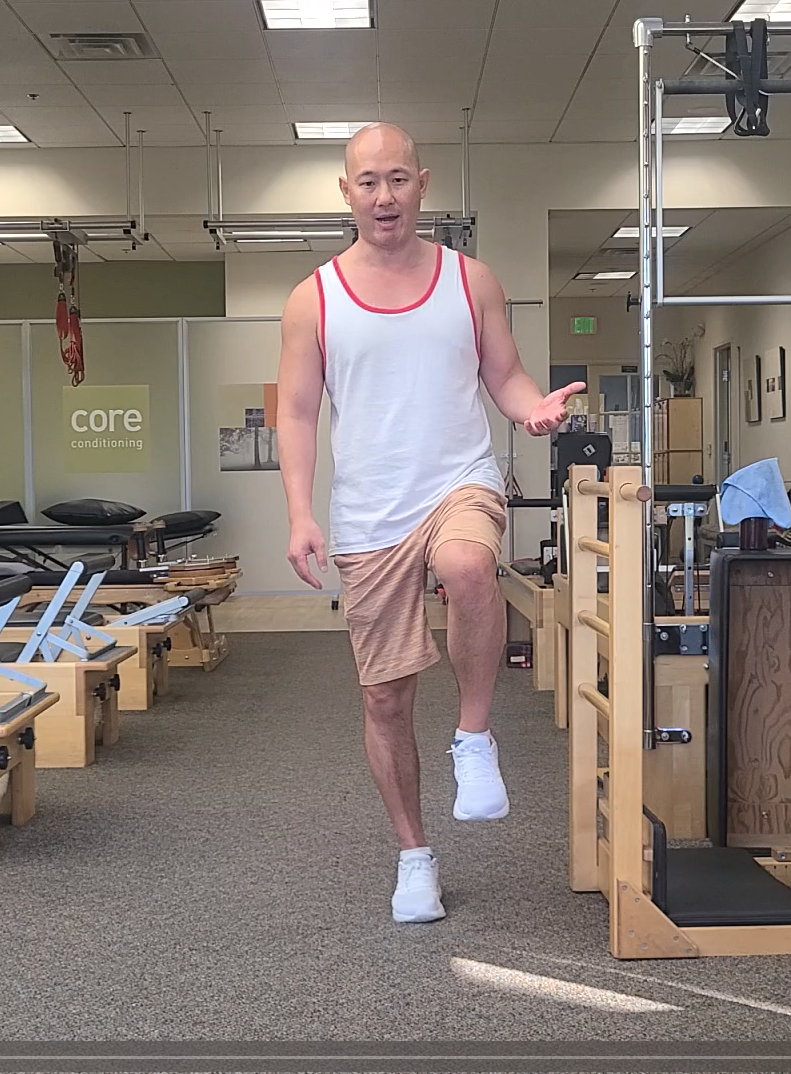 a man in a white tank top and shorts