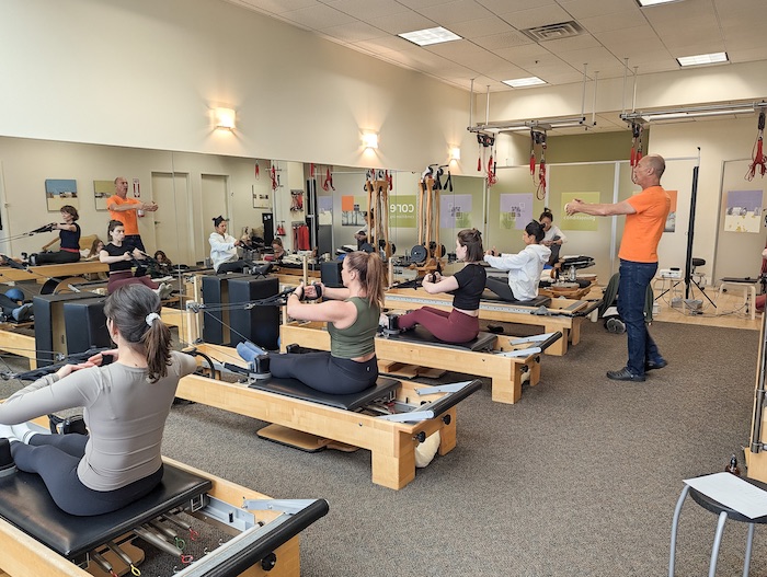 a group of women exercising in a gym