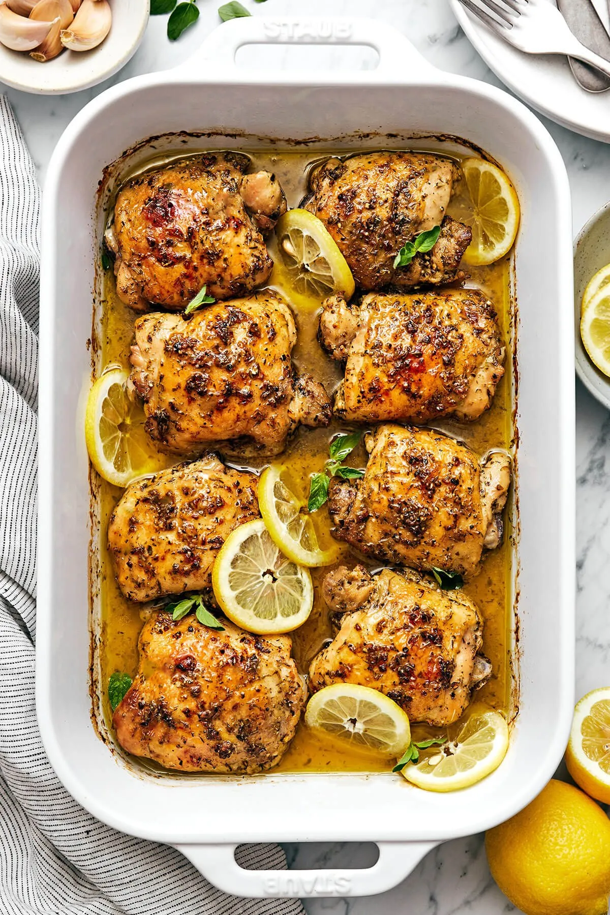 a dish of chicken with lemons and herbs