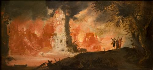 Painting: ‘The Destruction of Sodom and Gomorrah’ by François de Nomé (called Monsù Desiderio). In the background, an ancient city is engulfed in flames. Much of the city has already been consumed by the flames. What remains is skeletal and looks ready to collapse. In the foreground, a path leads away from the city. A man is being escorted along the path, by two angels. The path, the man, and the angels are all in shadow, being lit only by the blazing city behind them.