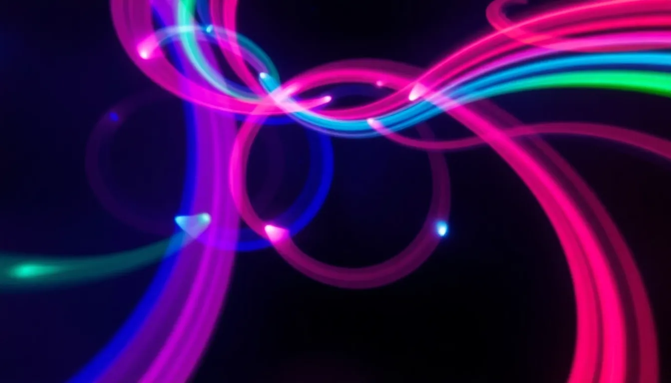 This vibrant image showcases an abstract light painting created with swirling colors and dynamic motion. Utilizing long exposure techniques, the colorful LED lights produce energetic trails against a dark backdrop. The circular symmetry of the composition draws the viewer's eye to the center, while neon pink, blue, and green colors create a lively atmosphere. Ideal for digital backgrounds, this artwork embodies creativity and movement, making it perfect for modern design applications.