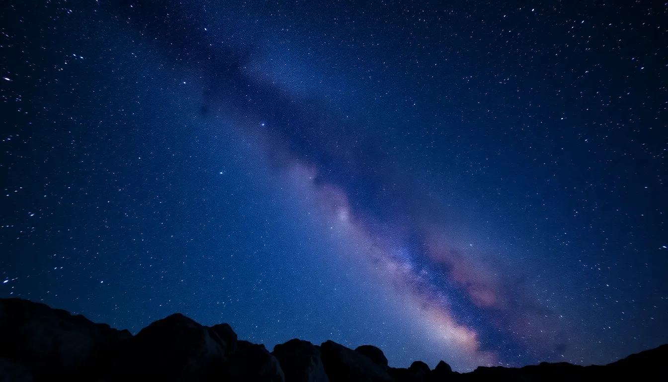 In this serene landscape, a star-filled night sky showcases multiple galaxies and the majestic arch of the Milky Way overhead. The natural lighting casts a soft glow, creating a tranquil atmosphere that envelops the viewer. With sharp focus from foreground to infinity, the deep blue and purple color palette beautifully highlights celestial wonders, making this image perfect for cosmic and astronomical themes.