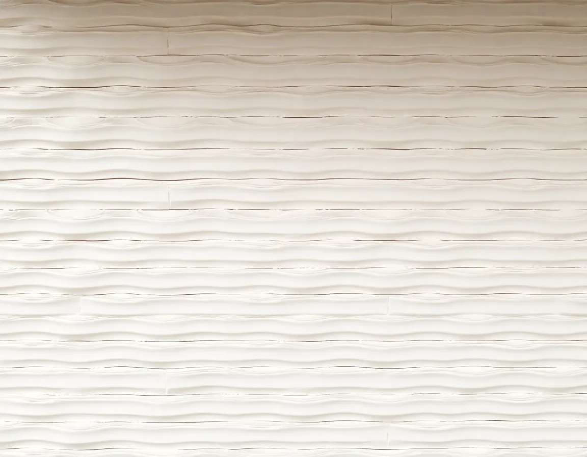 This mesmerizing image showcases a wall featuring a repeating wave-like pattern that creates a sense of motion and depth. Soft, diffused daylight from an overcast sky illuminates the surface evenly, revealing the intricate textures of the material. The muted color palette of off-white and grey enhances the calming ambiance, while the off-center placement of the pattern draws the eye in. This image is perfect for design inspiration or as a soothing backdrop.