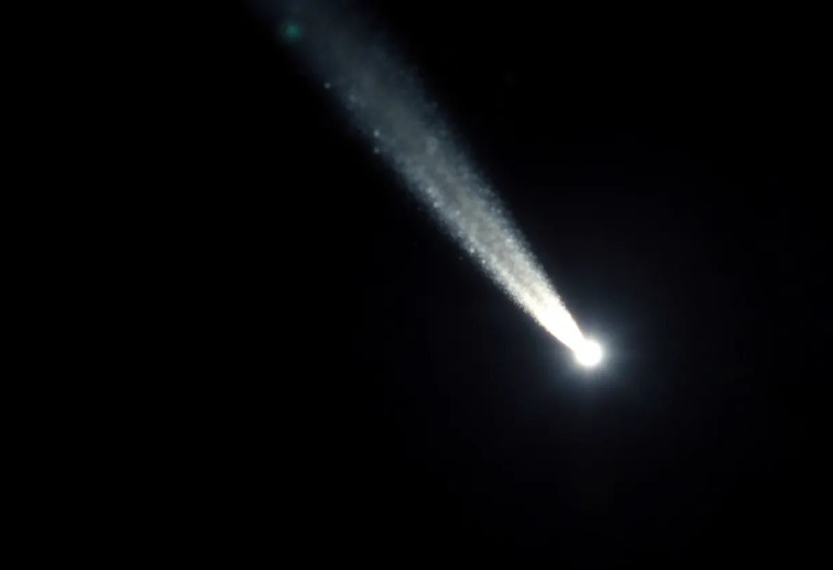 This captivating close-up depicts a comet streaking through the dark expanse of space, its icy core glistening in sunlight while leaving a luminous tail behind. The vivid whites and blues contrast sharply against the deep black backdrop, creating an ethereal and mysterious atmosphere. The focus is razor-sharp on the comet, drawing attention to its details while the surrounding space fades away into velvety darkness. The composition skillfully uses negative space to emphasize the comet's trajectory, inviting viewers to ponder the wonders of our cosmos.